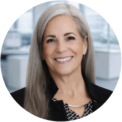 Sheila-Dolbow-926 - Texas Hospital Association Smiling professional woman with long gray hair, in a modern office setting.