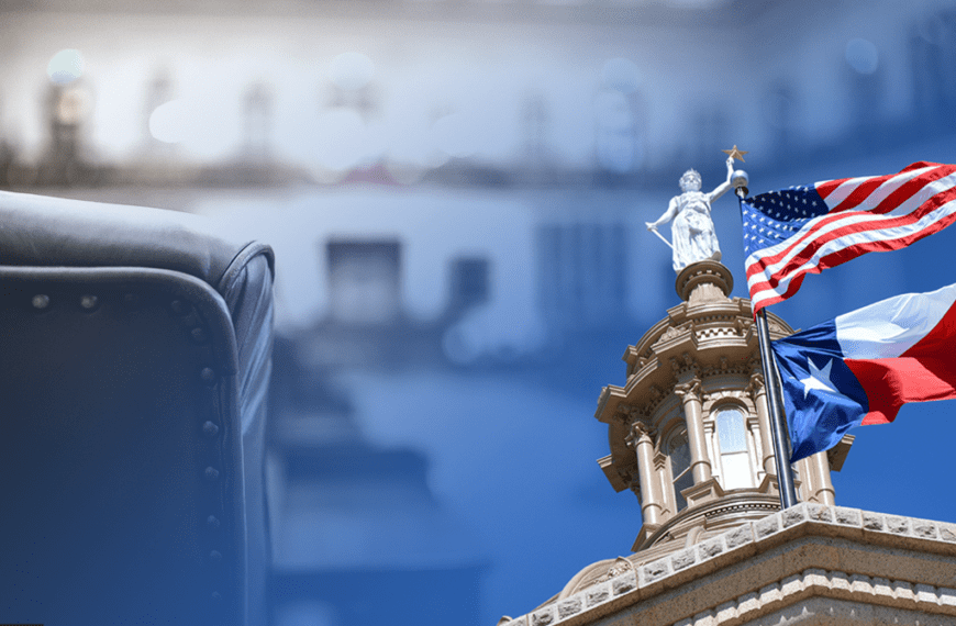 Leather chair in the foreground with a government building and waving US and Texas flags in the background.