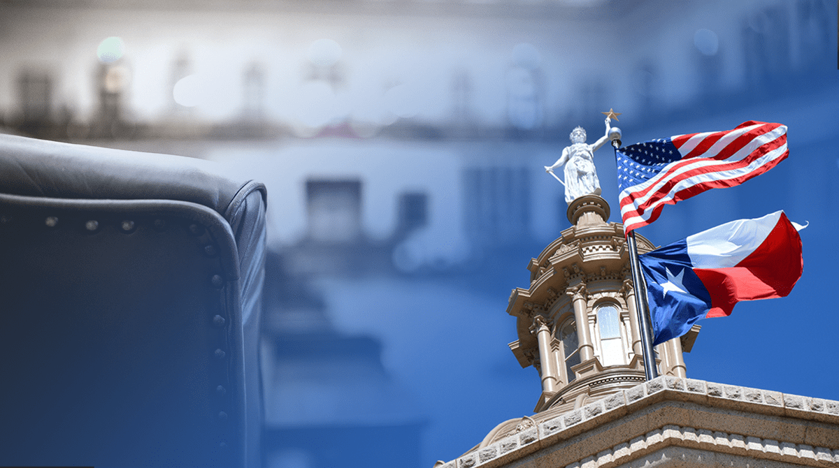 Leather chair in the foreground with a government building and waving US and Texas flags in the background.