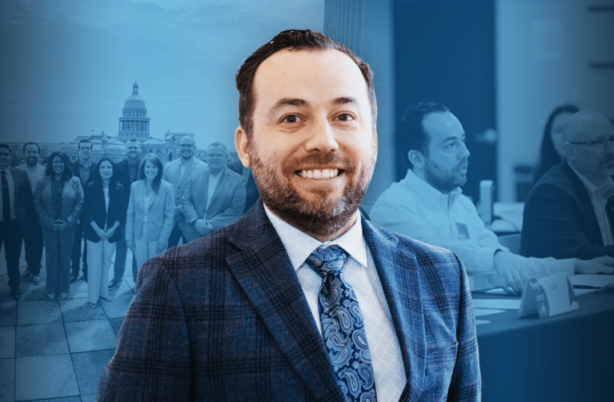 Smiling man in a checkered suit in the foreground with a group of professionals and a government dome in the background, blue-tinted image.