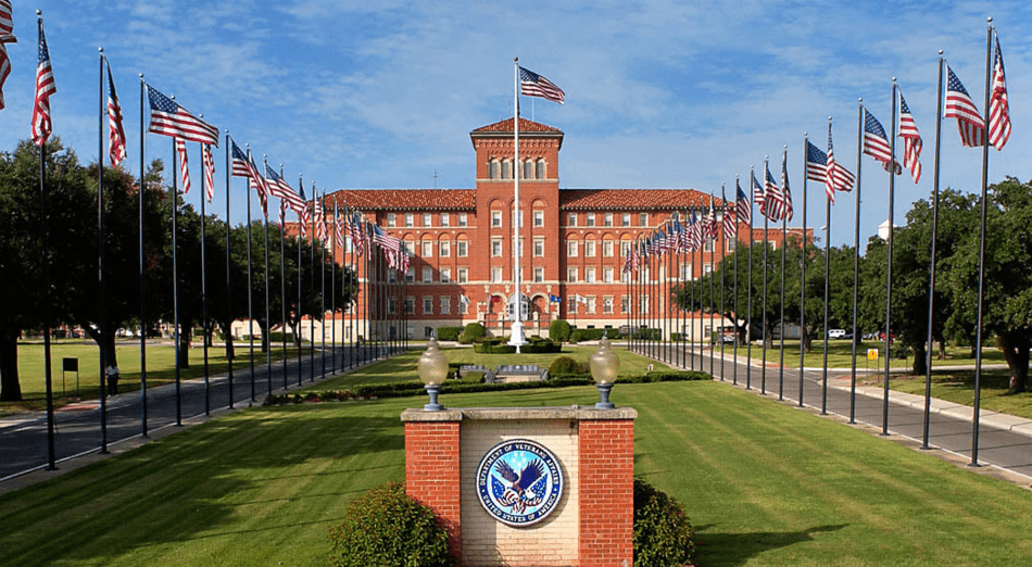 ctvhcs - Texas Hospital Association photo of the Central Texas Veterans Health Care System campus, with the building in the distance across a field of flag poles flying the American flag