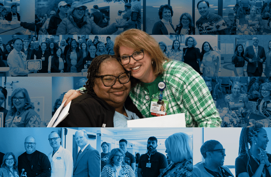 Two smiling women hug in the foreground at a conference, with a blue-tinted collage of team photos behind them.