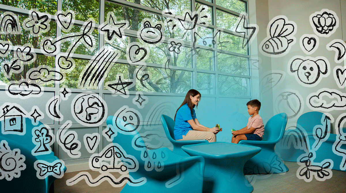Woman and child talk in a bright blue seating area, doodles on glass walls convey a playful, welcoming space
