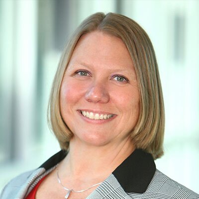 Tabitha-South - Texas Hospital Association Professional headshot: smiling woman with short blonde hair in a gray plaid blazer, neutral background.