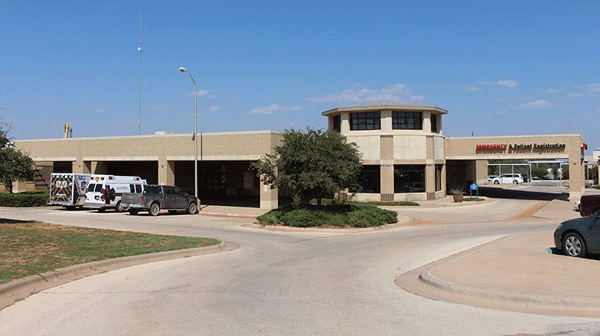Rolling Plains Memorial Hospital - Texas Hospital Association Medical clinic entrance with a curved drive-thru, ambulance parked to the left, and a'Mammography' sign overhead (patient registration visible).