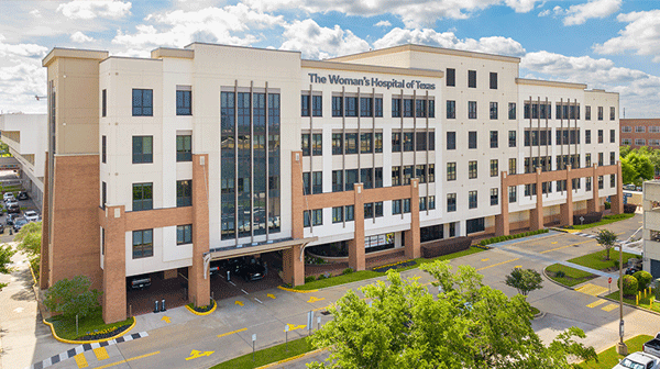 The Woman's Hospital of Texas - Texas Hospital Association The Woman's Hospital of Texas, a modern multi-story hospital with brick columns and a glass facade view from the front.
