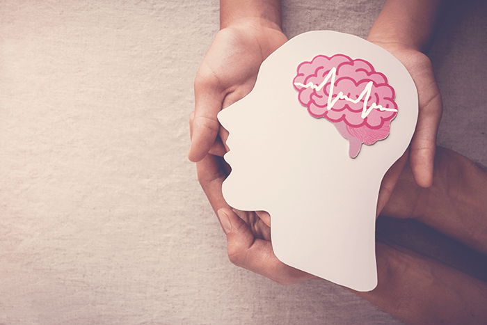 mental-health_lg - Texas Hospital Association Adult and child hands holding an encephalography brain paper cutout