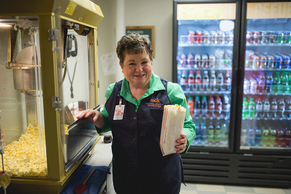 Hospital volunteers help with all sorts of duties, including serving popcorn.